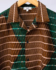 Display of  brown, camel, green and black diamond shaped geometric print shirt