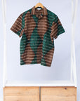 Display of  brown, camel, green and black diamond shaped geometric print shirt