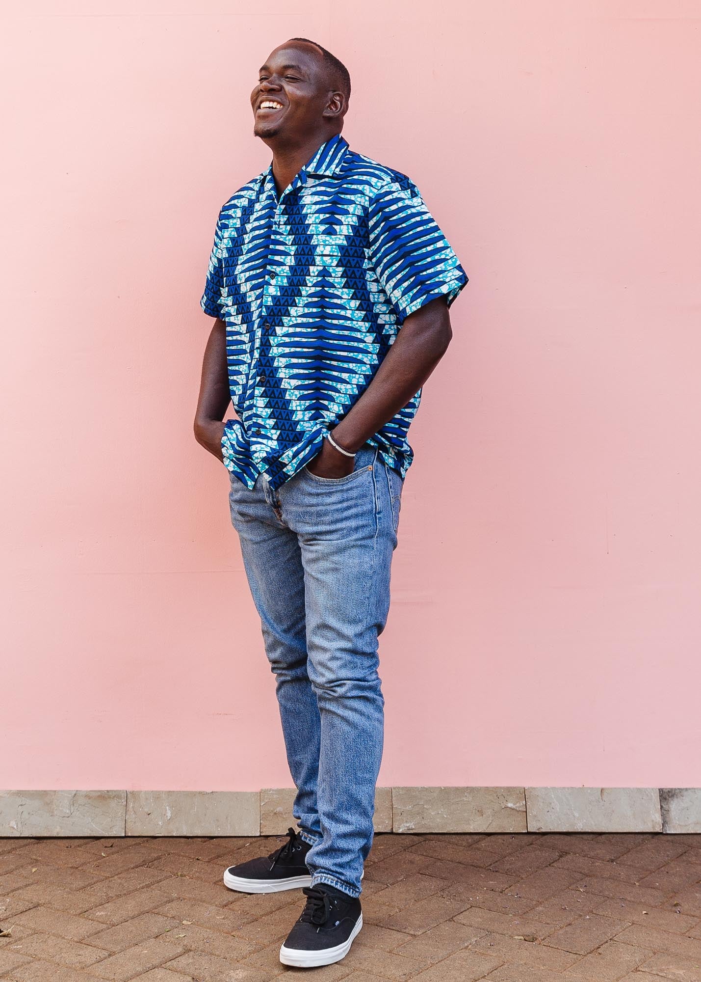 The model is wearing blue, sky blue and white colored men's shirt