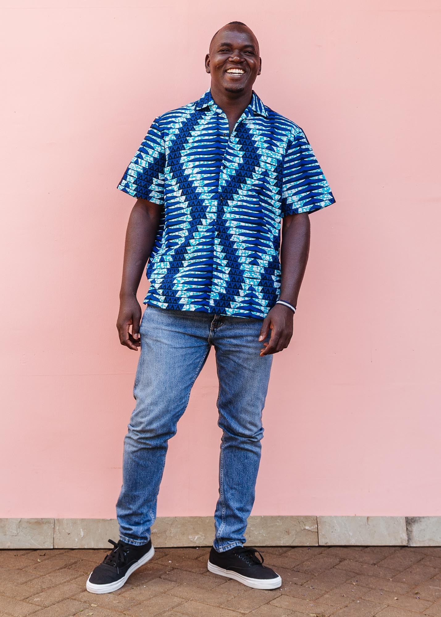 The model is wearing blue, sky blue and white colored men's shirt