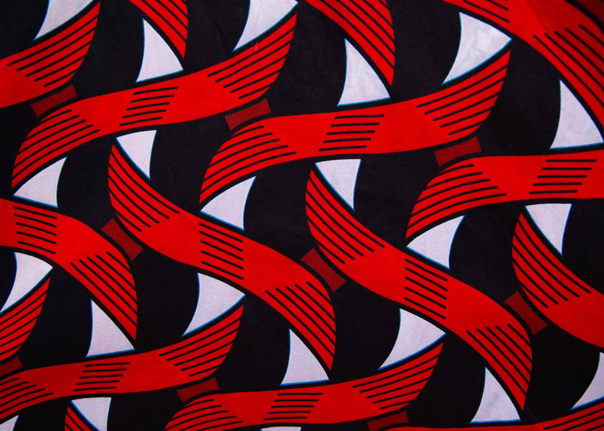 Display of red, black and white ribbon print dress, fabric.