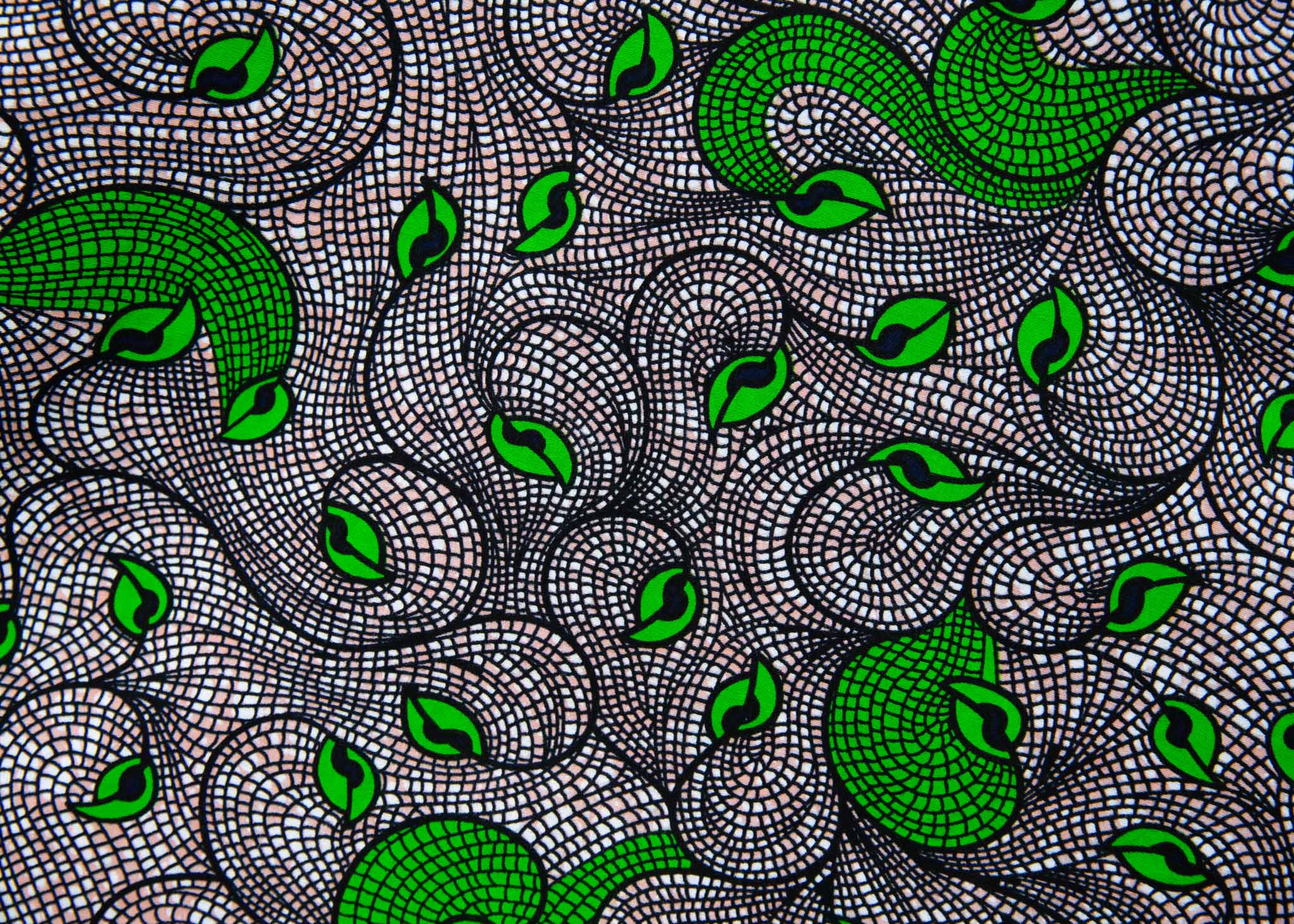 Close up Display of white and black dress with green swirls, fabric.