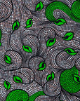 Close up Display of white and black dress with green swirls, fabric.