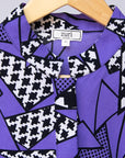 Display of purple, black and white geometric print dress