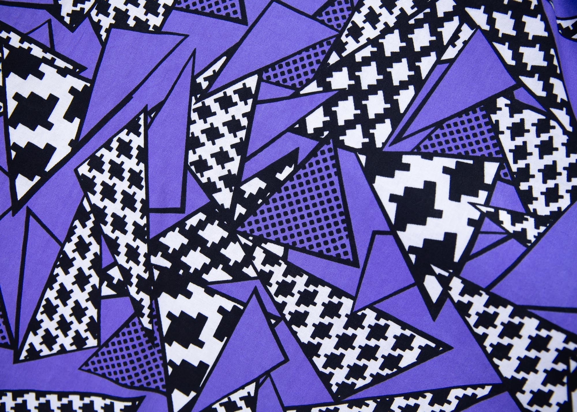 Close up display of purple, black and white geometric print dress