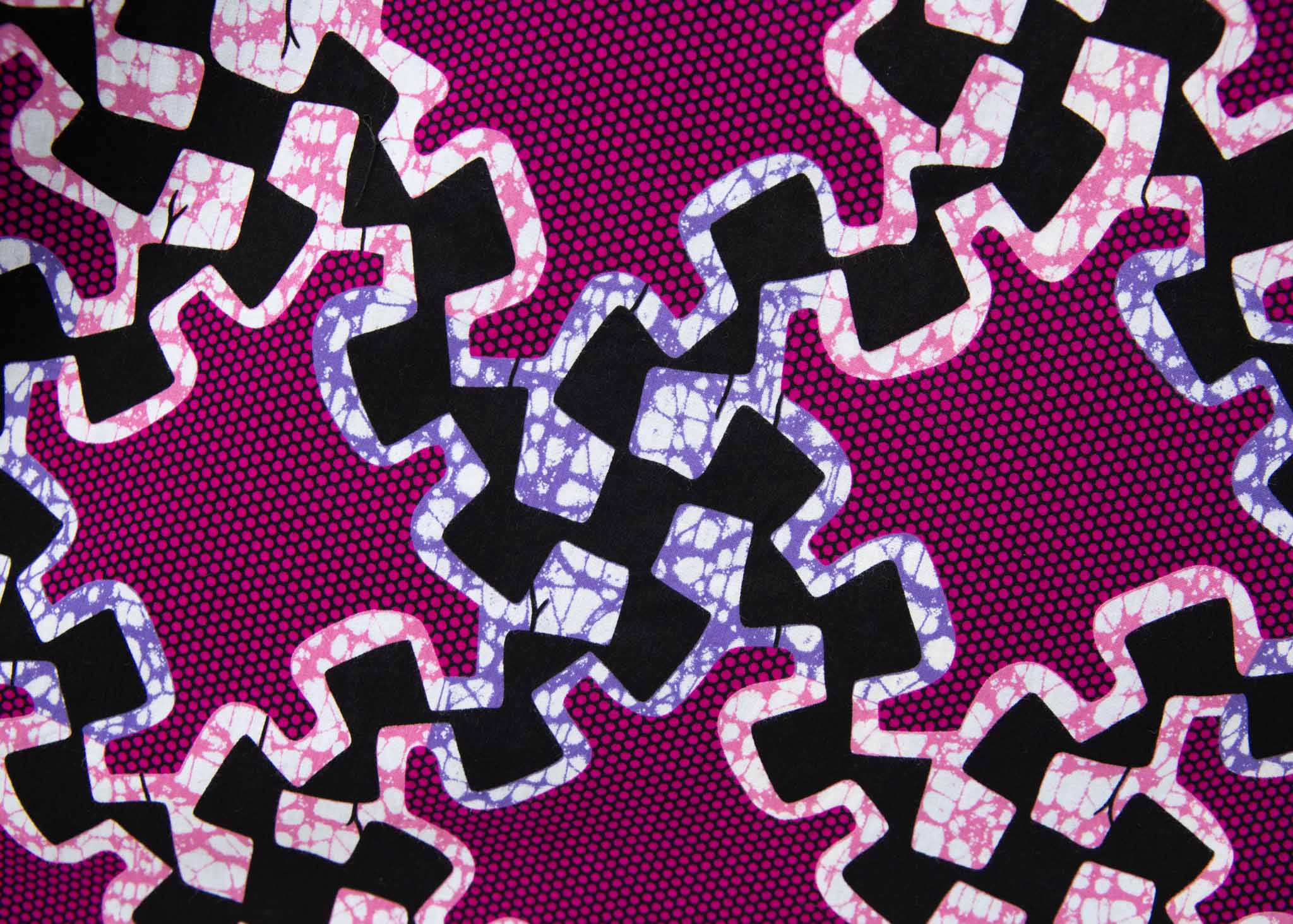 Display of purple dress with black and white puzzle print.