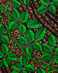 Display of brown dress with green vine print, fabric.