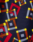 Close up of navy shirt with red, orange, yellow and white geometric print, fabric