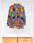 Display of multicolored long sleeved shirt with geometric print 