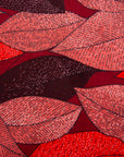 Close up display of red, brown, burgundy leaf print dress, fabric.