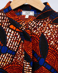 Display of brown, orange, blue and black leaf print dress.